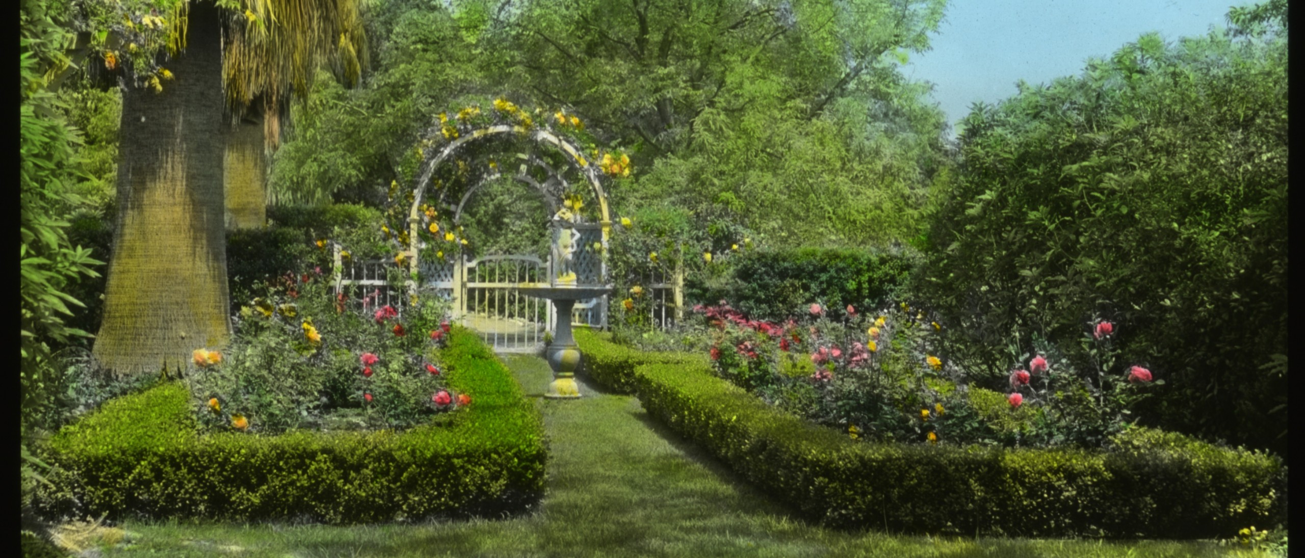 Formal garden with birdbath and trellis