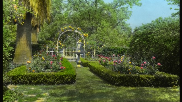 Formal garden with birdbath and trellis