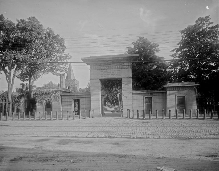 Black and white photo of cemetery gates.