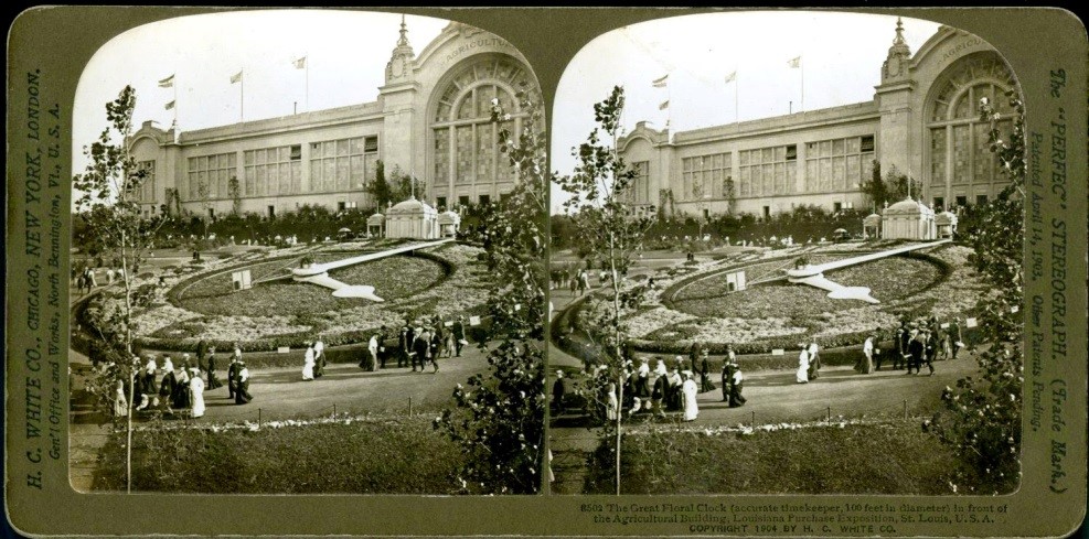 Stereoscope black and white image of a hillside featuring flowers planted in the shape of a clockface