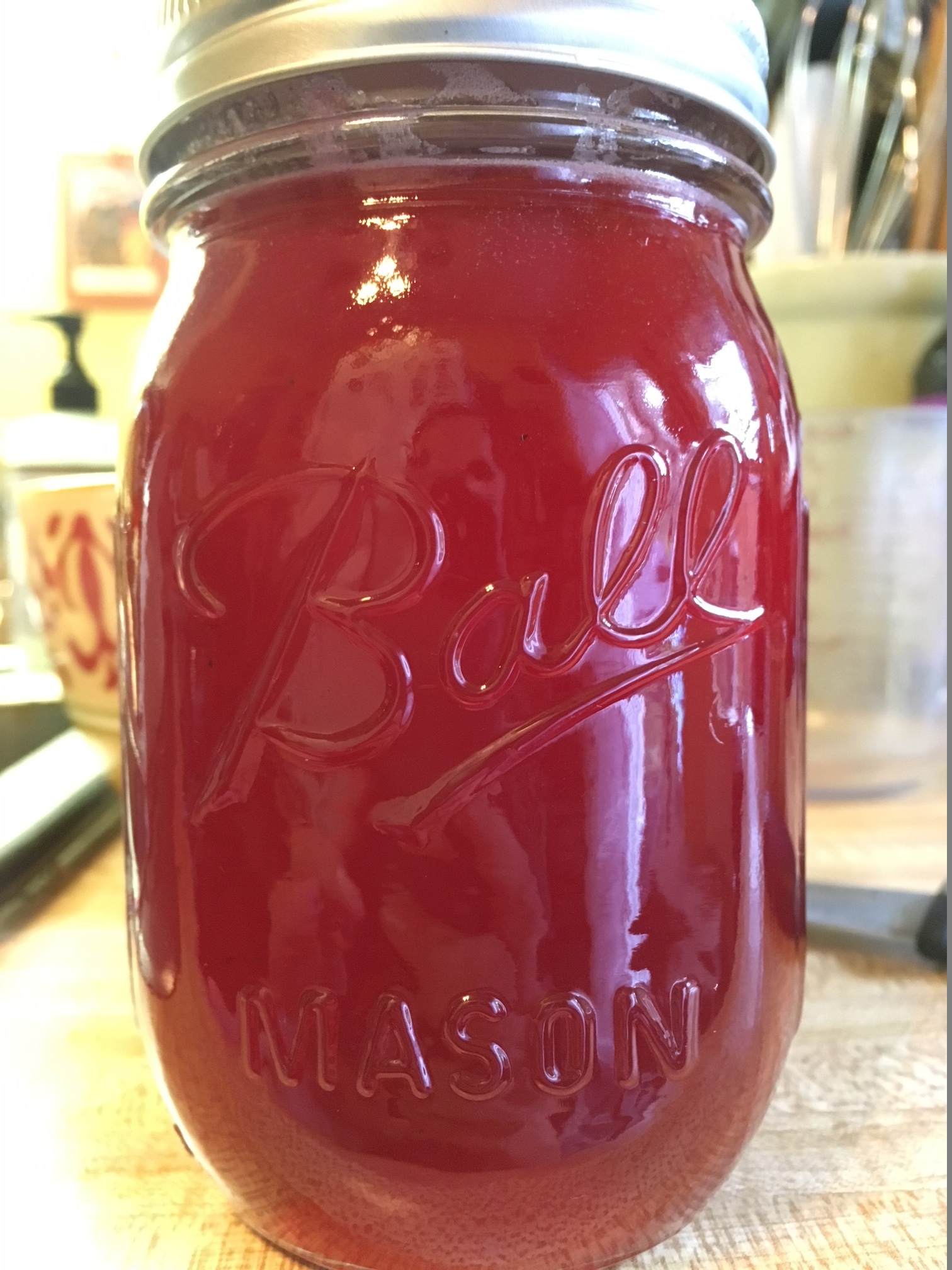 Mason jar of red beautyberry jelly