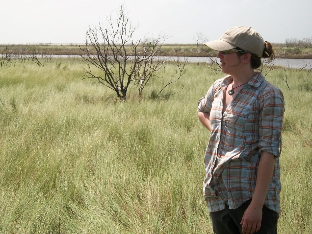 Woman standing in field of grass