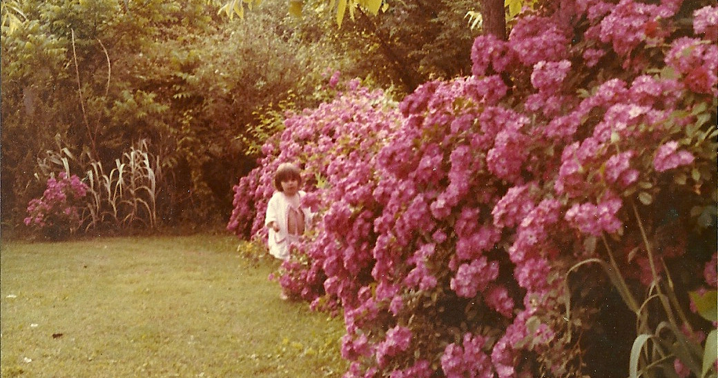 The author's sister in grandmother's rose garden