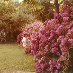 The author's sister in grandmother's rose garden