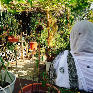 Posing in the lush backyard garden.