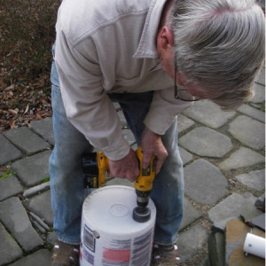 Adventures in Gardening: Highlights from a Garden Tinkerer. Drilling holes into the buckets to accommodate the fill tubes for the garden built using 55-gallon drums.