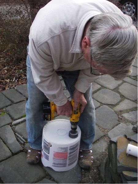 Adventures in Gardening: Highlights from a Garden Tinkerer. Drilling holes into the buckets to accommodate the fill tubes for the garden built using 55-gallon drums.