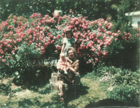 The author's sister in their grandmother's rose garden, Fort Payne, Alabama, 1975.