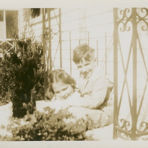 Posing outside of the sunporch at her family's home in New Orleans. Bridal wreath blooming in corner