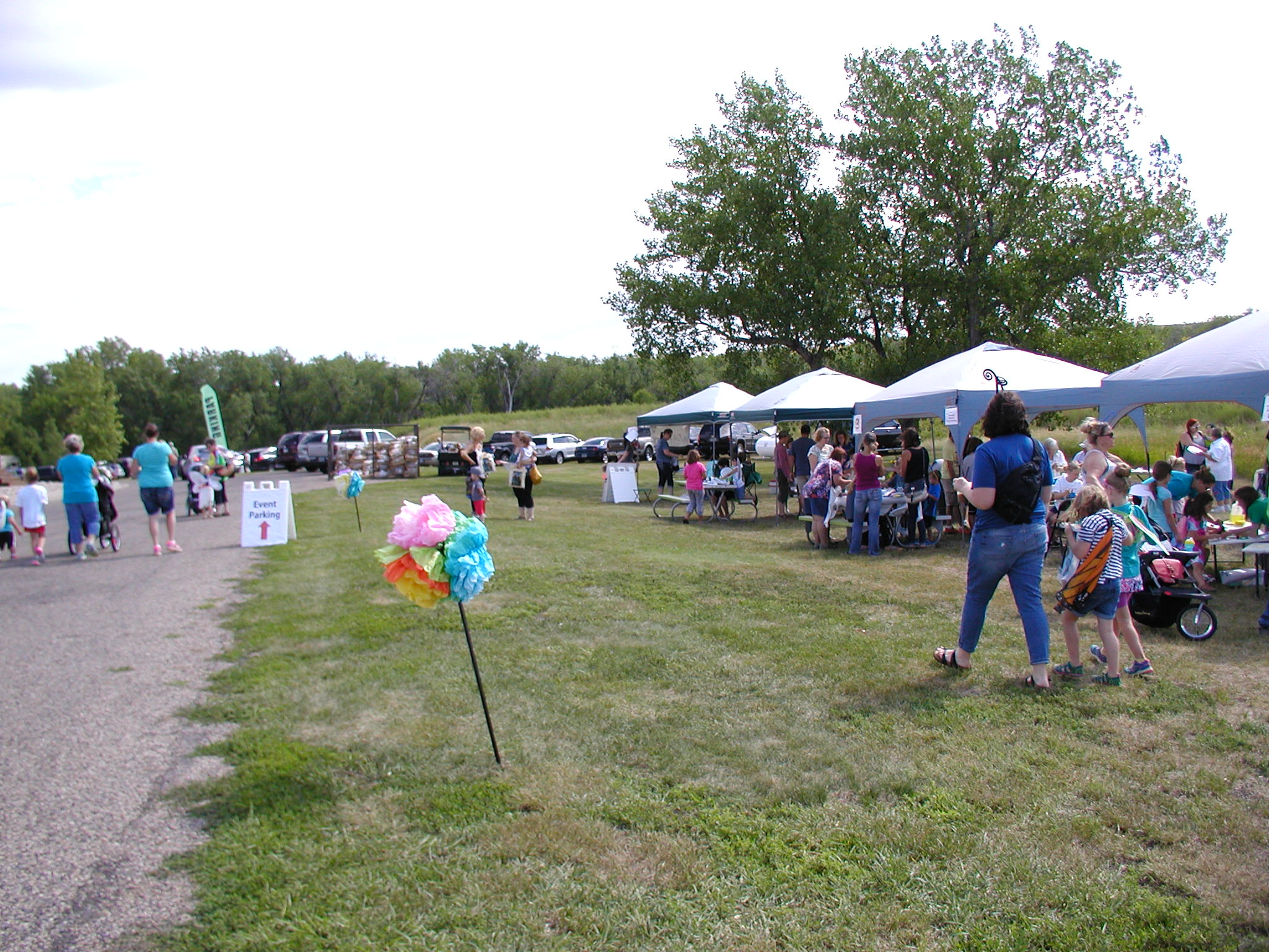 A view of the butterfly garden and its educational sign about prairie ecosystems.