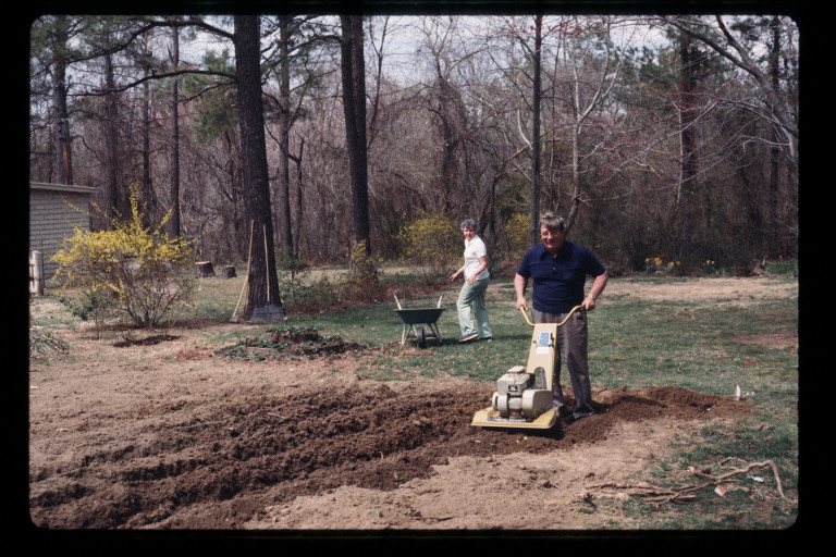 The author's parents tilling their garden