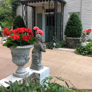 Four Seasons statues, urns and clipped, crisp edging of plant materials denotes the formality of arrival in the parking court.