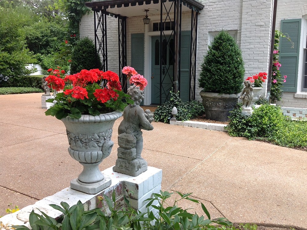 Four Seasons statues, urns and clipped, crisp edging of plant materials denotes the formality of arrival in the parking court.