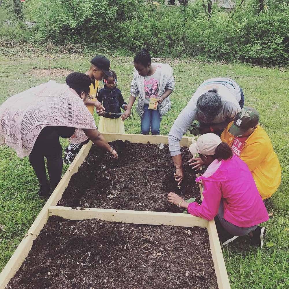 Even the youngest children help out in the Ancestral Roots Community Garden, Menlo Park Neighborhood.