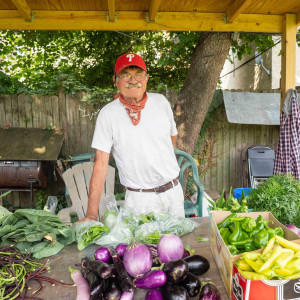 2022 photo taken by Milton Lindsay of garden founder John Lindsay at the farmstand for the Wiota Street Community Garden