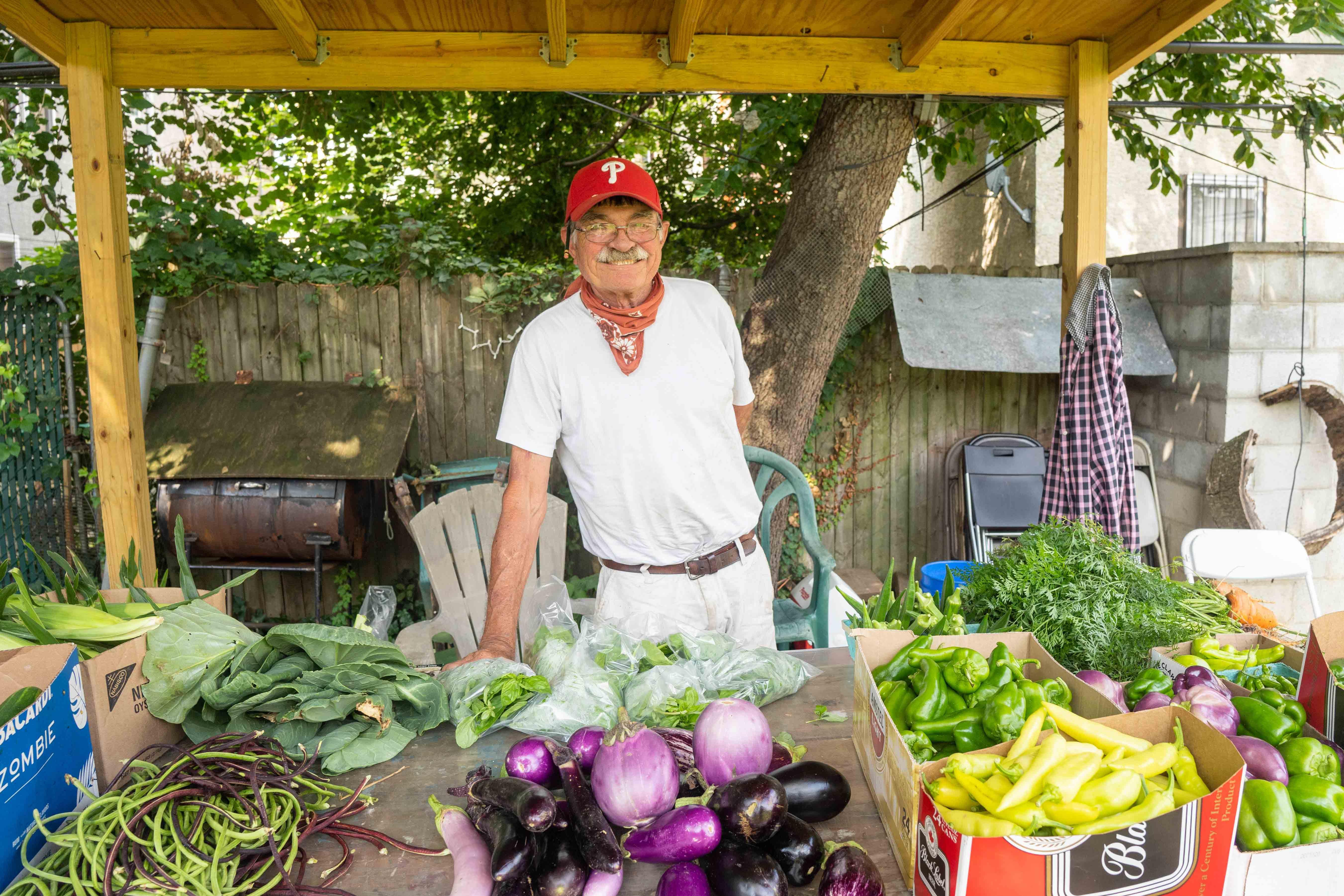 2022 photo taken by Milton Lindsay of garden founder John Lindsay at the farmstand for the Wiota Street Community Garden