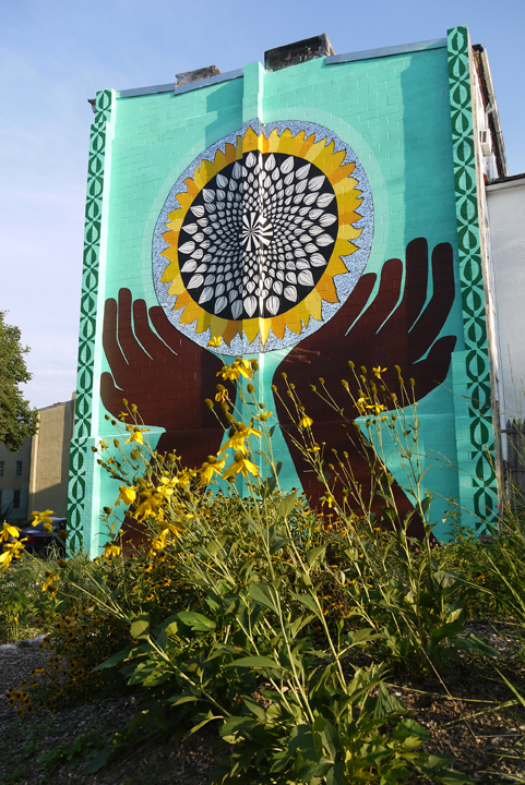 The design on the south wall. In 2010 it was transformed from just another abandoned lot into a beautiful community garden and meeting space.