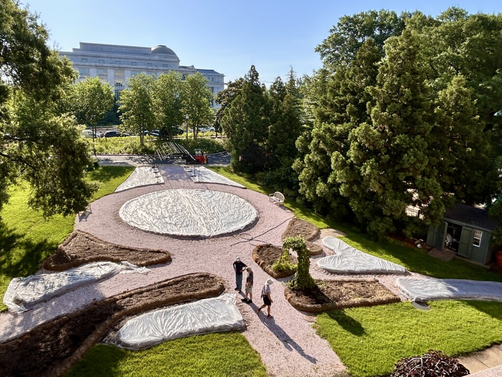 The Smithsonian Gardens’ horticulture team in the process of covering the Victory Garden beds with plastic.